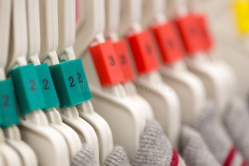 Clothes Hanger with Number Color Sizing Label. Stock Photo Image of