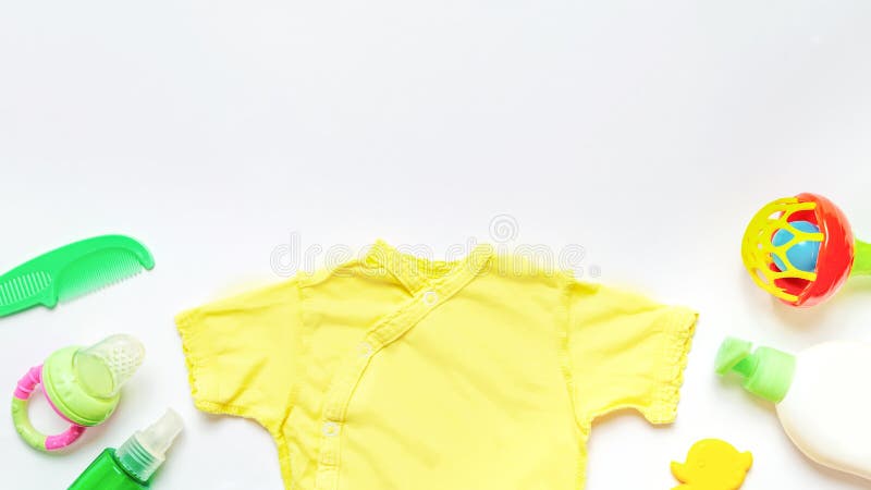 The clothes for kids for babies set with accessories on the white table. Baby background. Space for text. Flat lay