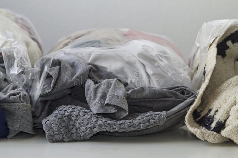 Clothes in plastic bags stock photo. Image of fabric 179130700