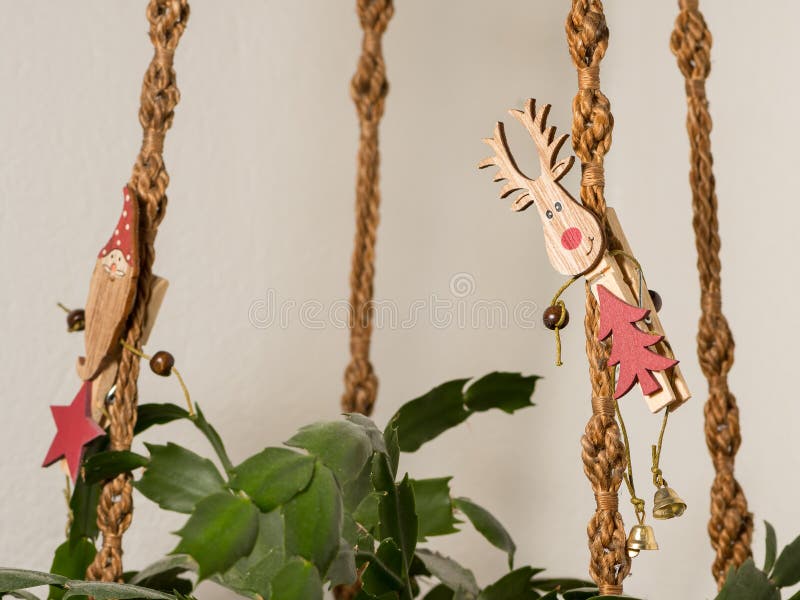 A clothespin with an elk on a knotted hanging basket at christmas