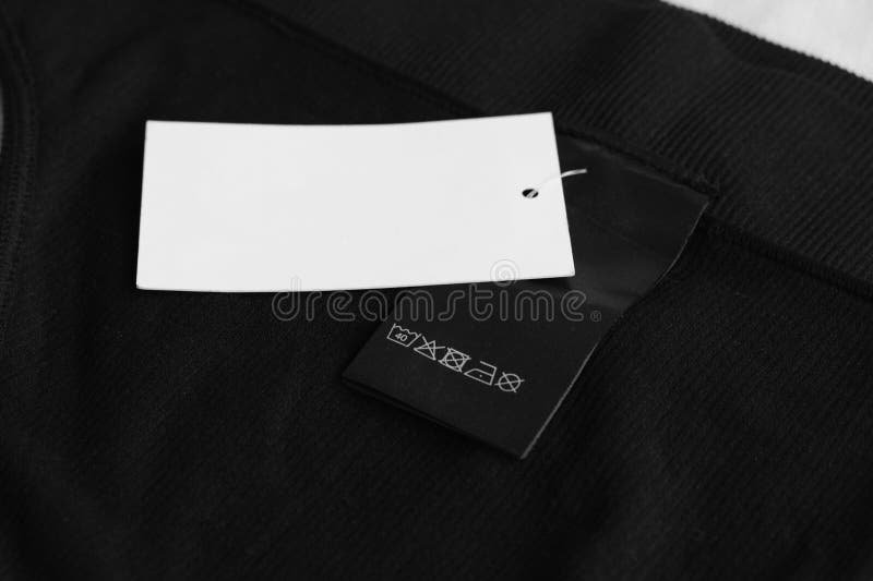 Clothing Label with Care Information and Tag on Black Garment Stock ...