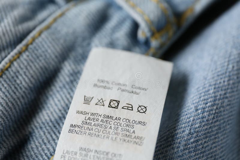 Clothing Label with Care Symbols and Material Content on Blue Jeans ...