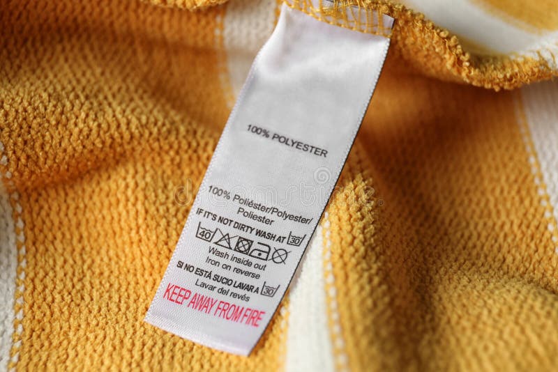 Clothing Label with Care Symbols and Material Content on Yellow Shirt ...