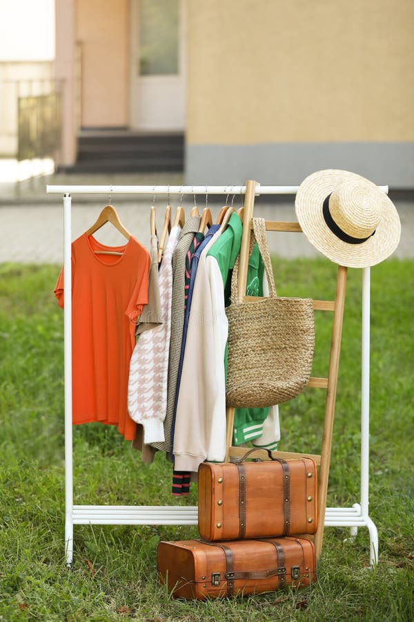 Clothing Rack with Different Garments in Yard. Garage Sale Stock Photo
