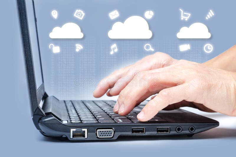 Cloud computing concept showing hands typing on computer keyboard with common Internet media icons around clouds from digital data royalty free stock photos