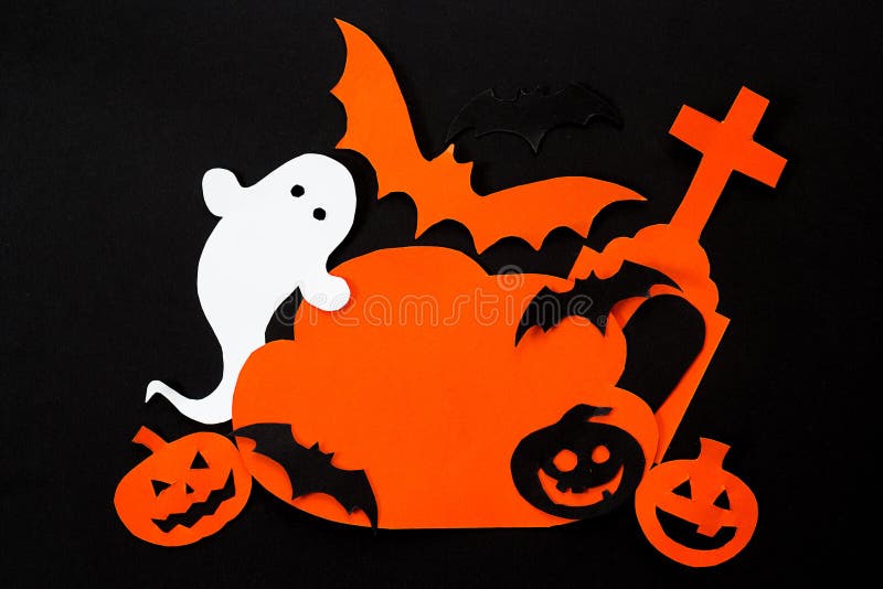 Cloud frame with ghost, pumpkin, bats, headstone cut out of paper. Happy Halloween card.