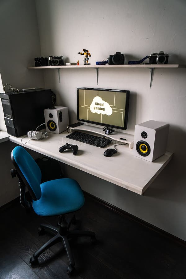 Cloud gaming: the workplace of a professional gamer with a monitor, gamepad, headphones and an armchair