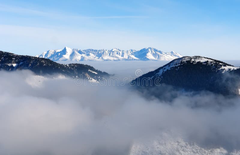 A cloud in the Low Tatras mountains and a view of the snowy peak