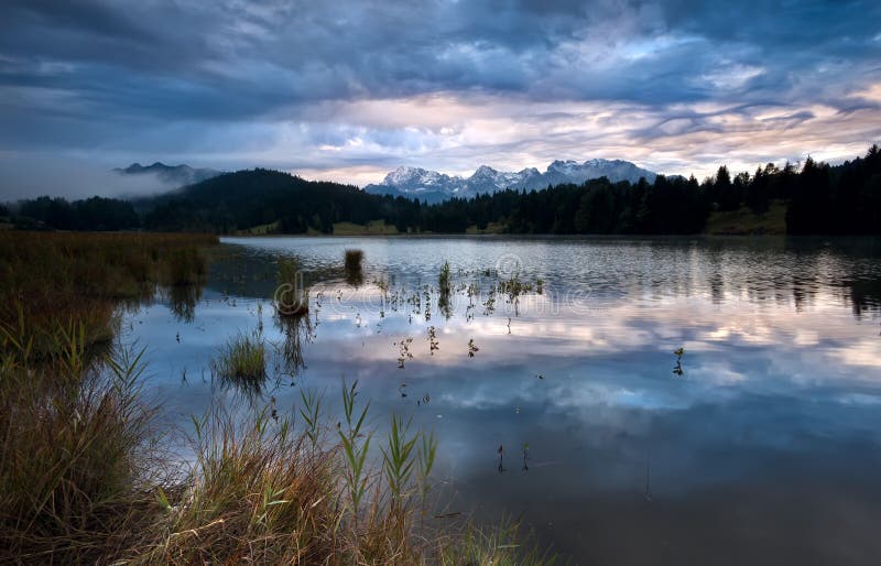 Clouded sunrise over Geroldsee in Bavarian Alps stock photo
