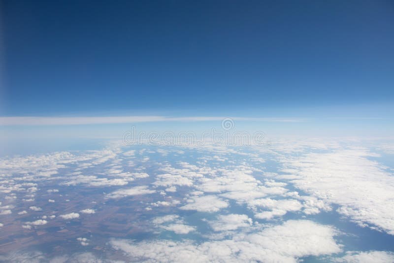 Cloudiness over the earth`s surface from a height during an airplane flight. Airplane height stock images, royalty-free photos and pictures