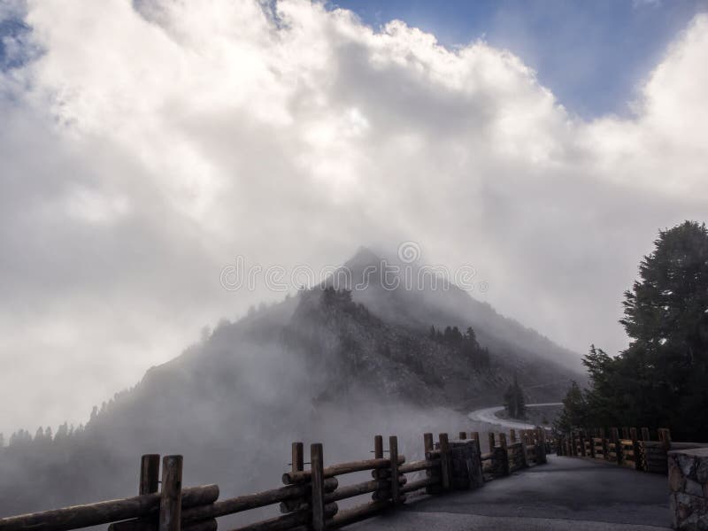 Clouds and mist at roadside mountain