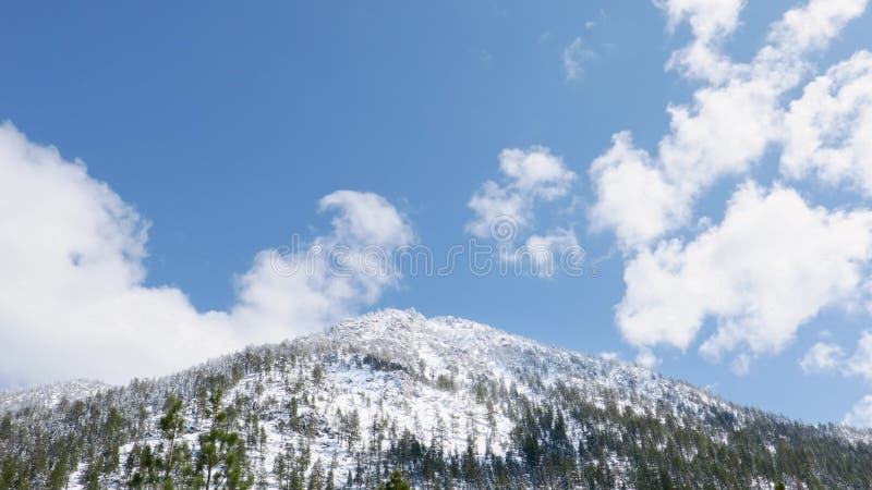 Clouds over snowy mountain stock video