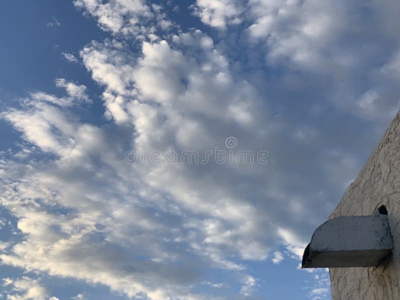 Clouds passing above a flat roof royalty free stock photo