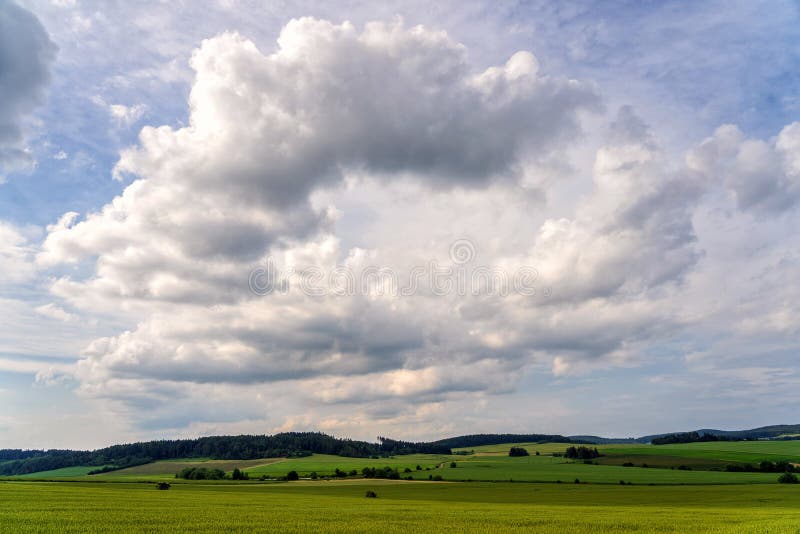Clouds passing above rural fields. stock photography