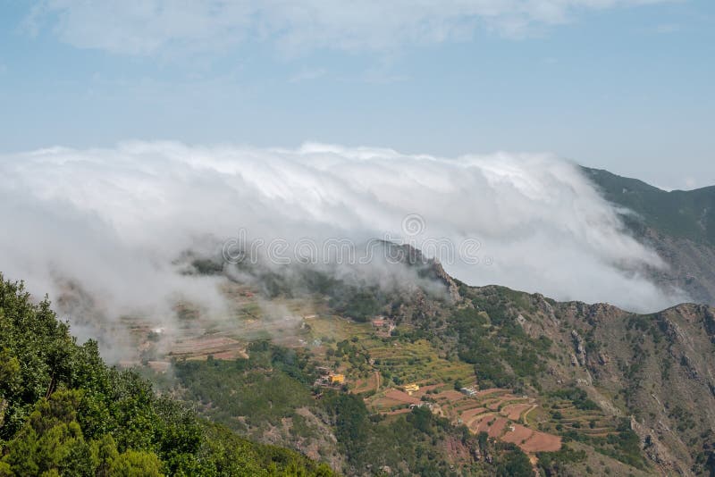 Clouds passing mountains - forest mountain landscape - stock photography