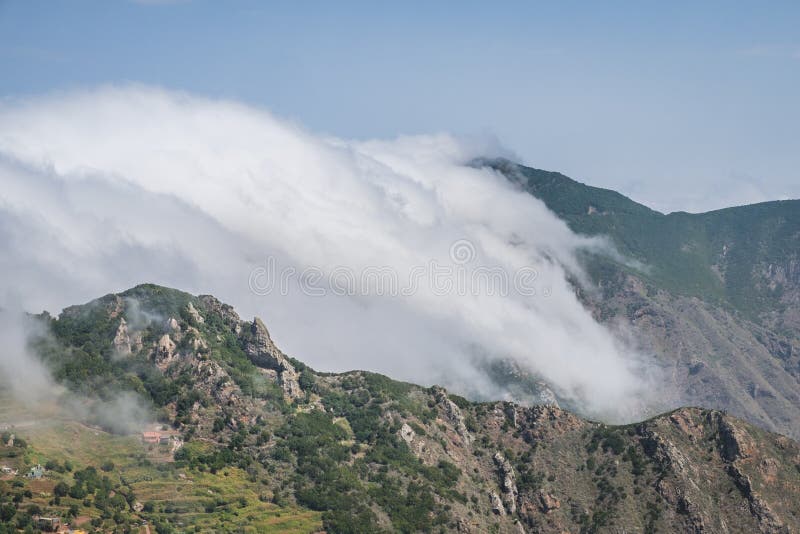 Clouds passing mountains - forest mountain landscape - stock images