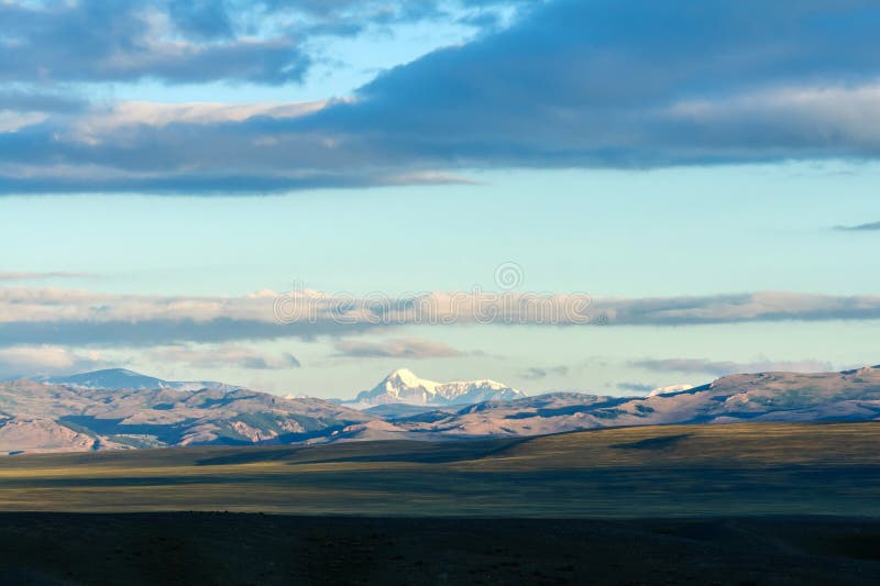 Clouds passing over mountain pinnackle in sunset light stock photos