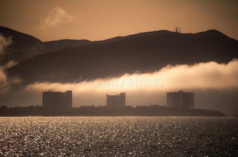 Clouds passing trough the City at sunset stock photo