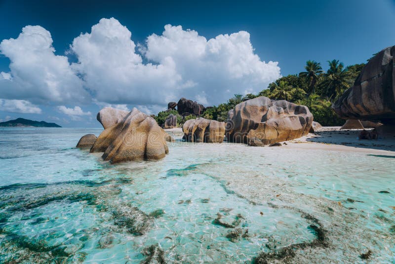 Impressive cloudscape above Anse Source D`Argent tropical beach, La Digue Seychelles. Luxury exotic travel concept. Impressive cloudscape above Anse Source D`Argent tropical beach, La Digue Seychelles. Luxury exotic travel concept.