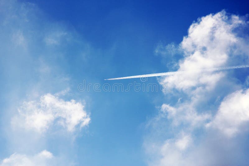 Cloudy blue sky jet trail stock image. Image of trail - 125565759