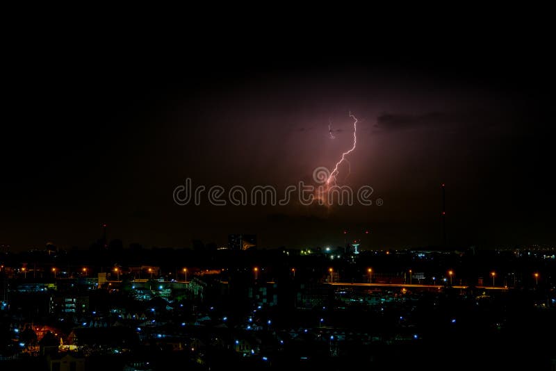 Cloudy with Bright lightning bolt strikes in the rural landscape of small city and satellite station. The Cloudy with Bright lightning bolt strikes in the rural stock photography Cloudy with Bright lightning bolt strikes in the rural landscape of small city and satellite station. The Cloudy with Bright lightning bolt strikes in the rural stock photography