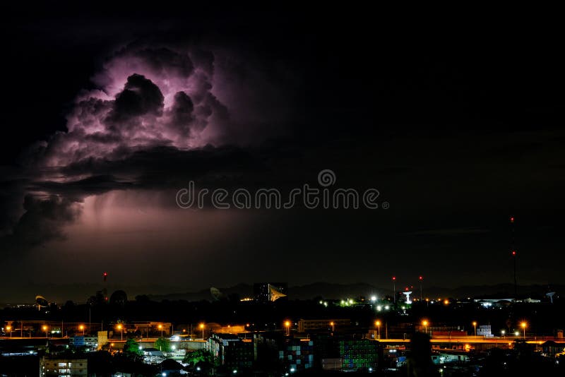 Cloudy with Bright lightning bolt strikes in the rural landscape of small city and satellite station. The Cloudy with Bright lightning bolt strikes in the rural stock photography Cloudy with Bright lightning bolt strikes in the rural landscape of small city and satellite station. The Cloudy with Bright lightning bolt strikes in the rural stock photography