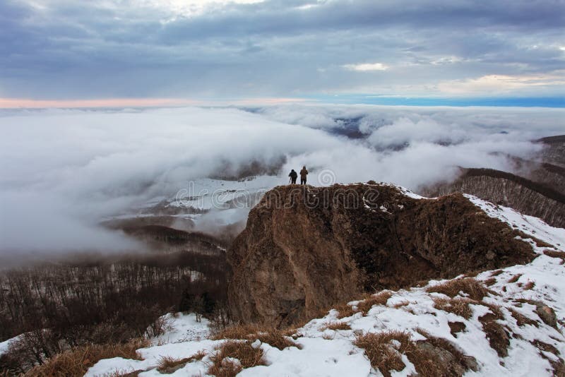 Cloudy mountain at winter with man