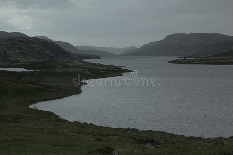 Cloudy rainy dreary landscape with views of the lake and mountains. royalty free stock images Cloudy rainy dreary landscape with views of the lake and mountains. royalty free stock images