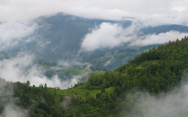 Cloudy Rural Mountain Landscape With Summer Morning Fog In Matisesti Area Of Apuseni National Park, Romania. Beautiful Countryside stock photography Cloudy Rural Mountain Landscape With Summer Morning Fog In Matisesti Area Of Apuseni National Park, Romania. Beautiful Countryside stock photography