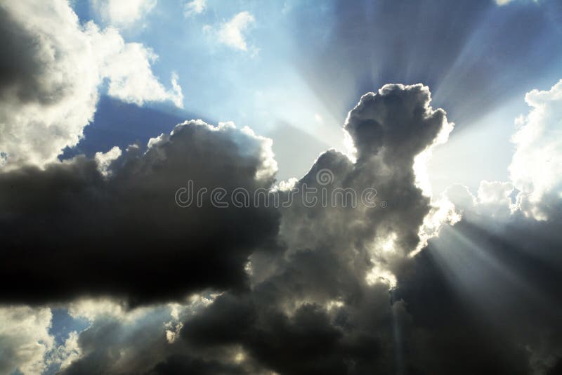 Cloudy sky with sunrays