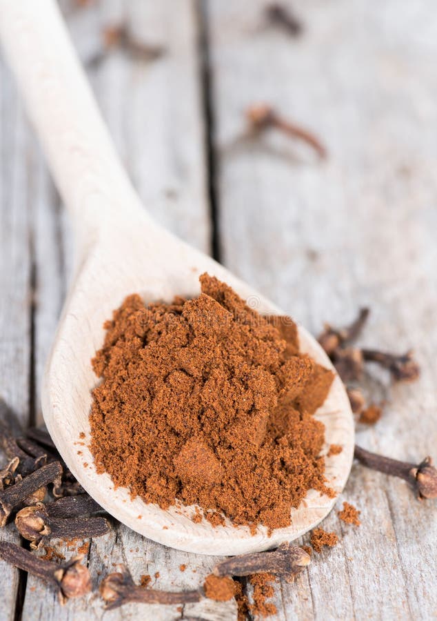 Clove Powder on a wooden spoon royalty free stock images