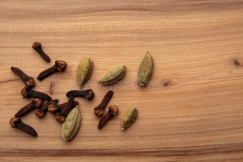 Cloves and Cardamom Pods on a Wooden Table. Stock Image Image of