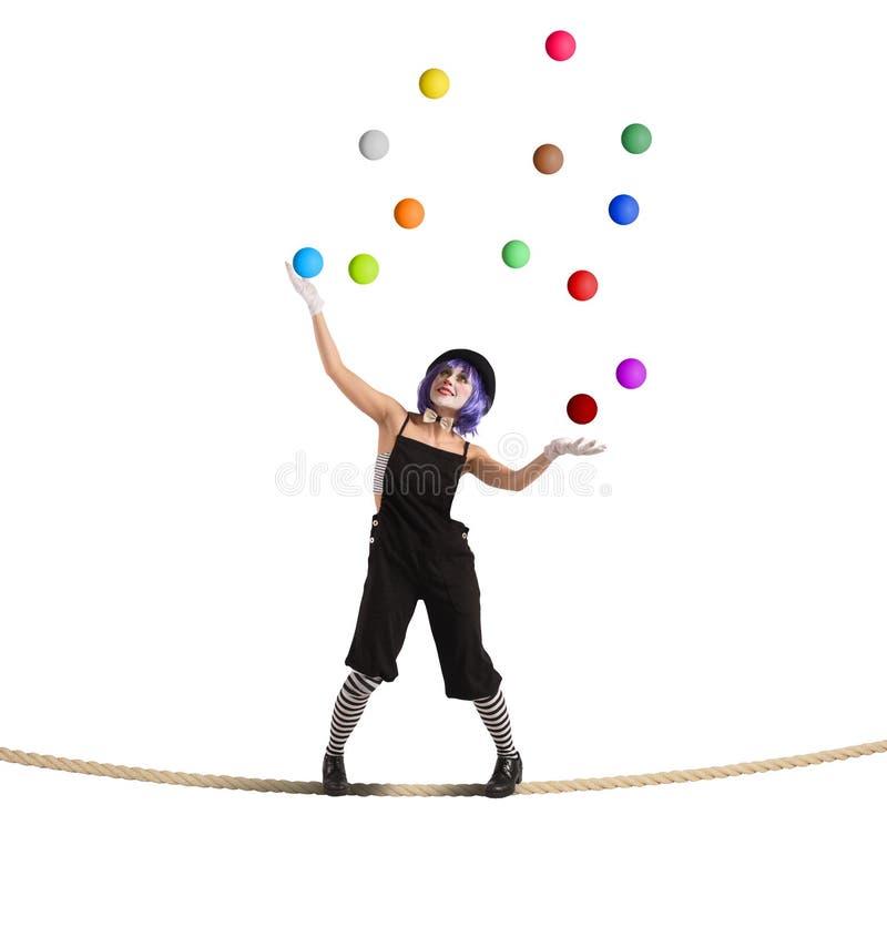 Clown as juggler is balancing on rope. Clown as juggler is balancing on rope