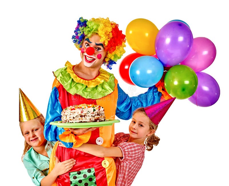 Clown med balooninnehavkakan på födelsedaggruppen arkivfoton Clown med balooninnehavkakan på födelsedaggruppen arkivfoton