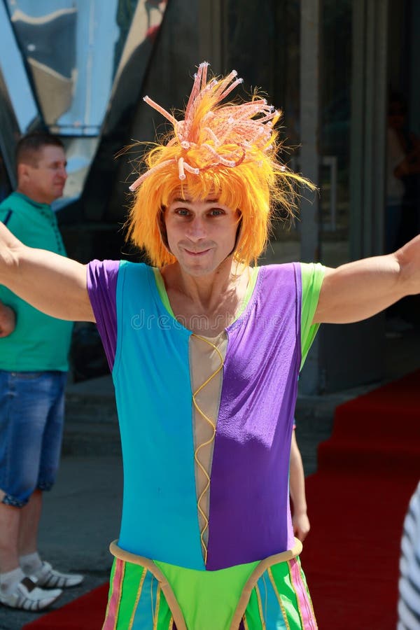 Kislovodsk, Russia - July 18, 2015: Clown with orange wig near entrance to the circus. Kornilovs show Carnaval of Elephants