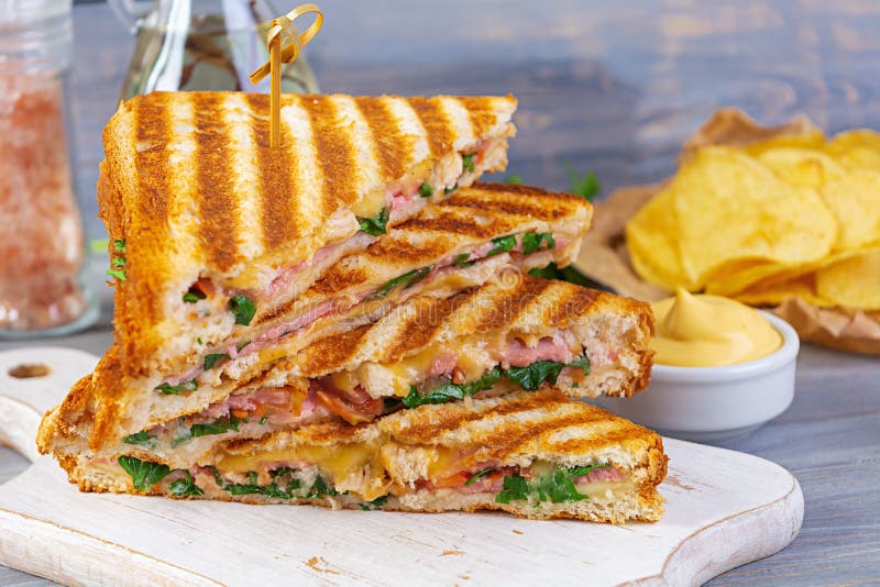 Club Sandwich with Ham, Cheese, Tomato, Salad and Chips Stock Image
