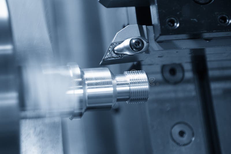 The CNC lathe machine thread cutting the metal shaft parts. The hi-technology metal working processing by CNC turning machine