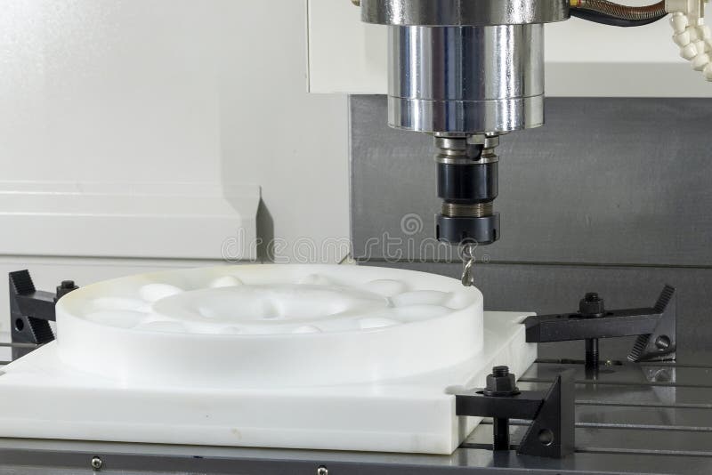 CNC Milling Machine Cutting Nylon Parts with Solid Ball Nose End Mill royalty free stock image