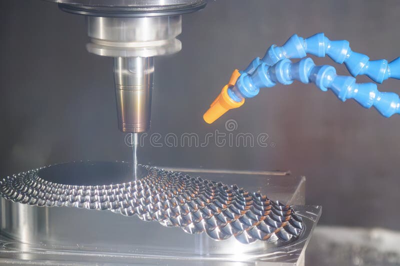 The CNC milling machine finish cut the mold parts by solid ball nose end mill tool stock images
