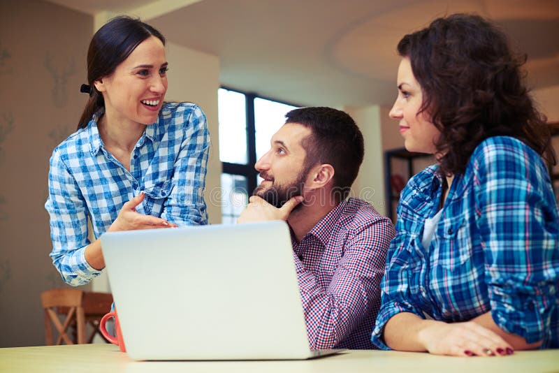 Co-workers Discussing Something on Working Place Stock Image - Image of