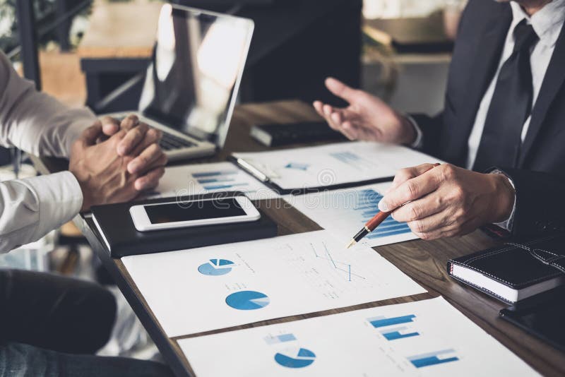 Co working conference, Business team meeting present, investor colleagues discussing new plan financial graph data on office table royalty free stock photos