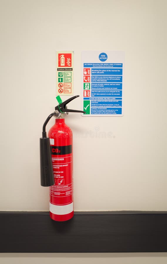 CO2 Fire Extinguisher with Safety Instructions on Hospital Wall. Stock