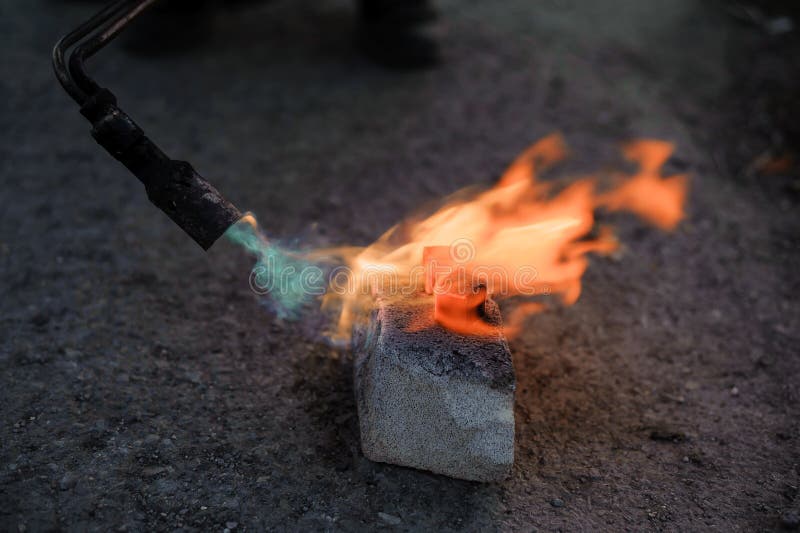 Coal on Fire. Ignition of Square Coal with a Gas Burner on a Stone