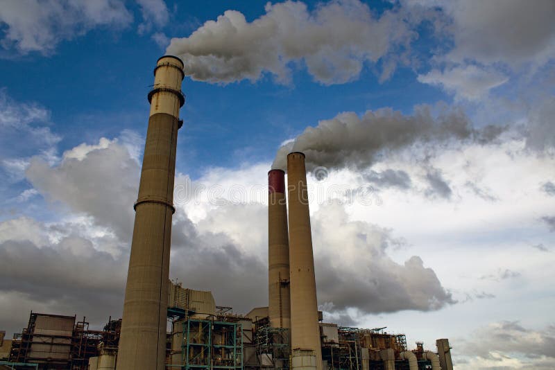 Coal-fired Power Plant with Three Smokestakes Spewing Steam Stock Photo