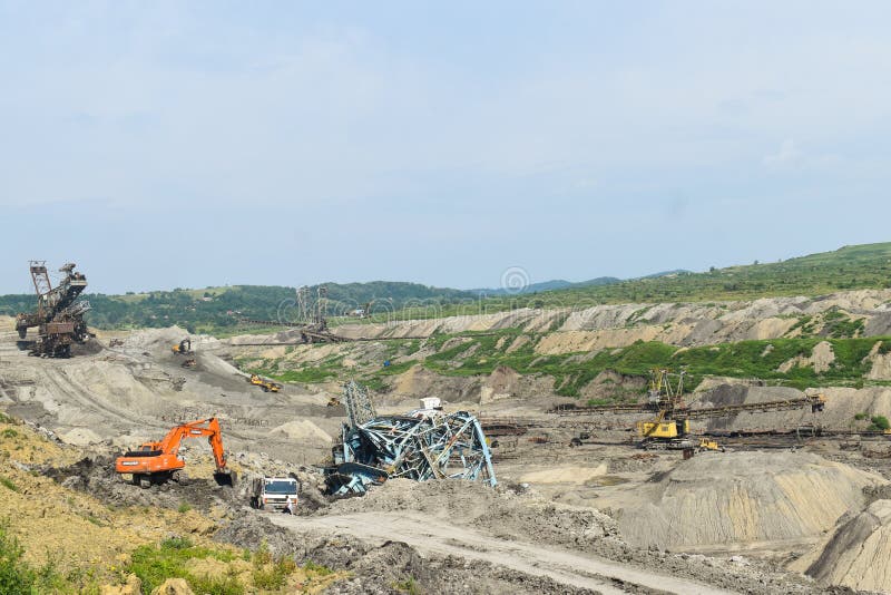 Coal mine accident with a heavy extraction machine inside the coal exploitation. The huge excavator collapsed in the open pit. stock photos Coal mine accident with a heavy extraction machine inside the coal exploitation. The huge excavator collapsed in the open pit. stock photos