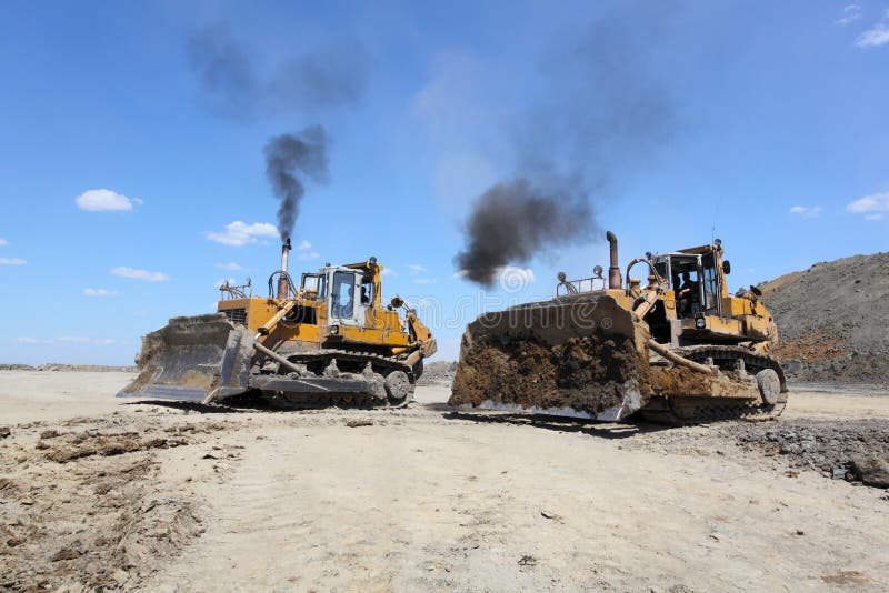 Coal mining. Two yellow bulldozers. Coal mining. Two yellow bulldozers.