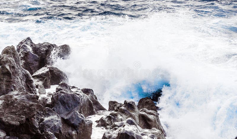 Coast with Stones of volcanic flow and ocean