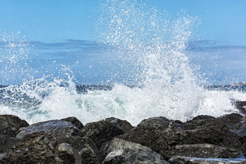 On the Coastal Rocks a Tidal Wave is Broken into Small Sprays Stock