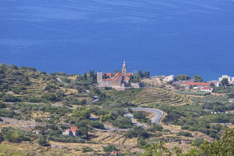 Coastal town lying on the island of Vis on the Adriatic Sea, view on Church of Saint Nicholas, Komiza, Croatia