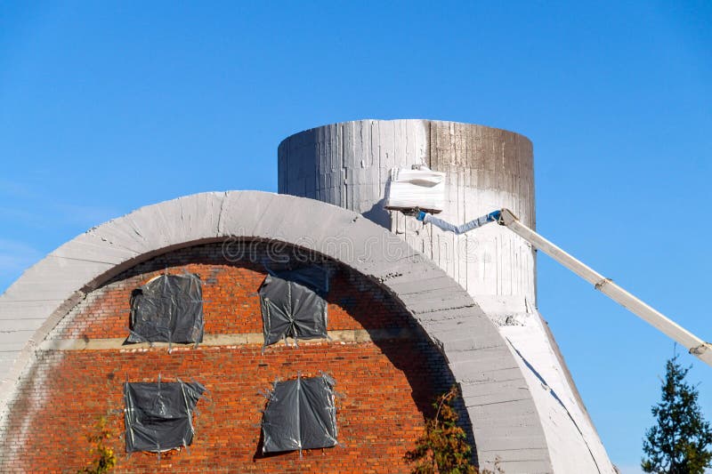 Coating the Building Structure with White Lime. Painting a Concrete
